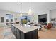 Modern kitchen island with white cabinets and a large quartz countertop at 930 Monterey Ne Pt, St Petersburg, FL 33704