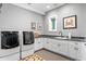 Bright laundry room with modern washer, dryer, and ample counter space at 930 Monterey Ne Pt, St Petersburg, FL 33704