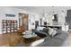 Open living space featuring a large sectional sofa, stylish coffee table, and hardwood floors at 930 Monterey Ne Pt, St Petersburg, FL 33704