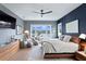 Main bedroom with king bed, sitting area, water views, and dark blue accent wall at 930 Monterey Ne Pt, St Petersburg, FL 33704
