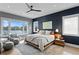 Spacious main bedroom boasts a king-size bed, sitting area, water views, and a navy accent wall at 930 Monterey Ne Pt, St Petersburg, FL 33704