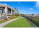 Landscaped backyard with waterfront view and fence at 930 Monterey Ne Pt, St Petersburg, FL 33704