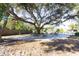 Large backyard with patio, picnic tables, and mature oak tree at 10215 Evening Trail Dr, Riverview, FL 33569