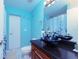 Bathroom with dark vanity, vessel sinks, and blue shower curtain at 10215 Evening Trail Dr, Riverview, FL 33569