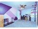 Bright bedroom with purple and pink geometric accent wall at 10215 Evening Trail Dr, Riverview, FL 33569