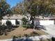 Single-story home with attached garage and landscaped yard at 10215 Evening Trail Dr, Riverview, FL 33569