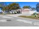 Residential home on a tree-lined street with a fire hydrant at 10215 Evening Trail Dr, Riverview, FL 33569