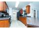 Kitchen with wood cabinets, granite countertops, and stainless steel appliances at 10215 Evening Trail Dr, Riverview, FL 33569