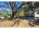 Relaxing patio area with picnic tables under a large oak tree at 10215 Evening Trail Dr, Riverview, FL 33569
