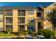 Two-story condo building with yellow exterior and ample parking at 11901 4Th N St # 9105, St Petersburg, FL 33716