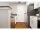 Modern kitchen with white cabinets, stainless steel appliances, and wood flooring at 11901 4Th N St # 9105, St Petersburg, FL 33716
