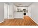 Modern kitchen with white cabinets, stainless steel appliances, and wood flooring at 11901 4Th N St # 9105, St Petersburg, FL 33716