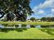 Peaceful backyard view of pond and lush landscape at 1213 Huntington Greens Dr, Sun City Center, FL 33573