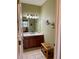 Bathroom features a vanity with wood cabinets and a tiled floor at 1213 Huntington Greens Dr, Sun City Center, FL 33573