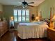 Bright bedroom with wood floors and a comfortable bed at 1213 Huntington Greens Dr, Sun City Center, FL 33573