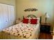 Guest bedroom with double closet and floral bedding at 1213 Huntington Greens Dr, Sun City Center, FL 33573
