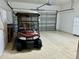 Two-car garage with golf cart and extra storage at 1213 Huntington Greens Dr, Sun City Center, FL 33573