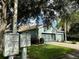 Exterior view of a house with a two-car garage and community mailboxes at 1213 Huntington Greens Dr, Sun City Center, FL 33573