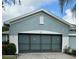 House exterior featuring a two-car garage and well-manicured landscaping at 1213 Huntington Greens Dr, Sun City Center, FL 33573