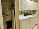 Laundry room with washer, dryer, and storage cabinets at 1213 Huntington Greens Dr, Sun City Center, FL 33573