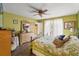 Bright bedroom with floral bedding and a ceiling fan at 12255 Katherwood St, Spring Hill, FL 34608