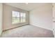 Spacious bedroom with large window and carpet flooring at 13278 Ogden Glade Rd, Dade City, FL 33525