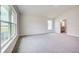 Spacious bedroom with large windows and plush carpeting at 13278 Ogden Glade Rd, Dade City, FL 33525