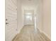Light and airy entryway with tile flooring and white doors at 13278 Ogden Glade Rd, Dade City, FL 33525
