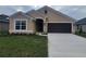 One-story house with brown garage door and neutral exterior at 13278 Ogden Glade Rd, Dade City, FL 33525