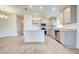 Open kitchen with gray cabinets, granite counters and island at 13278 Ogden Glade Rd, Dade City, FL 33525
