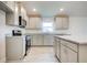 Modern kitchen with gray cabinets and granite countertops at 13278 Ogden Glade Rd, Dade City, FL 33525