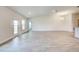 Spacious living area with tile flooring and access to patio at 13278 Ogden Glade Rd, Dade City, FL 33525