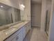 Double vanity bathroom with granite countertop and shower at 13290 Ogden Glade Rd, Dade City, FL 33525
