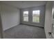 Spacious bedroom with neutral carpeting and large windows at 13290 Ogden Glade Rd, Dade City, FL 33525