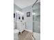 Updated bathroom with white vanity, gray tile shower, and neutral decor at 1613 Heather Pl, Palm Harbor, FL 34684