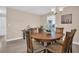 Bright dining room with wood table and chairs, offering a view into the kitchen at 1613 Heather Pl, Palm Harbor, FL 34684