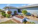 Front entrance with landscaping and a walkway leading to the door at 1613 Heather Pl, Palm Harbor, FL 34684