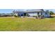 View of the house from the side, showing the landscaping and driveway at 1613 Heather Pl, Palm Harbor, FL 34684
