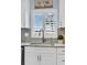 Kitchen sink with granite countertop and stylish faucet, featuring a window with plantation shutters at 1613 Heather Pl, Palm Harbor, FL 34684