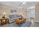 Living room featuring a gray sofa, wooden coffee table, and neutral decor at 1613 Heather Pl, Palm Harbor, FL 34684