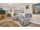 Relaxing living room with comfy chairs and a view into the dining area at 1613 Heather Pl, Palm Harbor, FL 34684