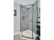 Walk-in shower with gray tile walls and glass enclosure at 1613 Heather Pl, Palm Harbor, FL 34684
