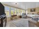 Bright sunroom features a wall of windows, comfy seating, and a tile floor at 1613 Heather Pl, Palm Harbor, FL 34684