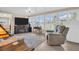 Sunroom with large windows, comfortable seating, and a fireplace at 1613 Heather Pl, Palm Harbor, FL 34684