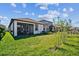 Spacious backyard with screened patio and grassy area at 18015 Fenders Way, Land O Lakes, FL 34638