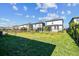 Large backyard with a grassy area and black metal fence at 18015 Fenders Way, Land O Lakes, FL 34638