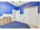 Cozy bedroom with blue walls and double closets at 18015 Fenders Way, Land O Lakes, FL 34638