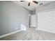 Bright bedroom with gray walls, carpet, and white doors leading to other rooms at 18015 Fenders Way, Land O Lakes, FL 34638