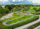 Aerial view of a community bike park with pump track and shaded seating at 18015 Fenders Way, Land O Lakes, FL 34638