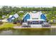Blue community center with a large deck overlooking a lake at 18015 Fenders Way, Land O Lakes, FL 34638